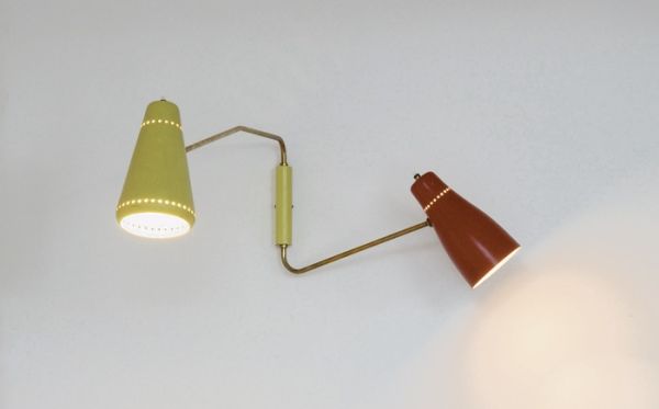 Applique à deux bras de lumière orientables avec abats-jour en métal laqué rouge et jaune sur tiges en laiton. 1952, Edition Disderot - fiftease. H : 30, P : 72 (cm / Visuel : D.R.